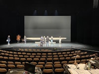 a group of people on stage in a large auditorium